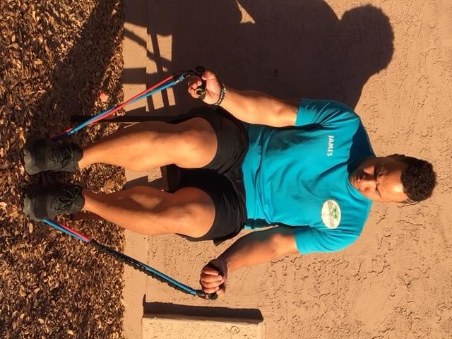 A man does a bicep curl as one of the resistance band workouts for seniors