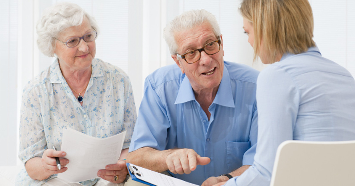 A lady explaining to a couple how to get Power of Attorney for an elderly parent