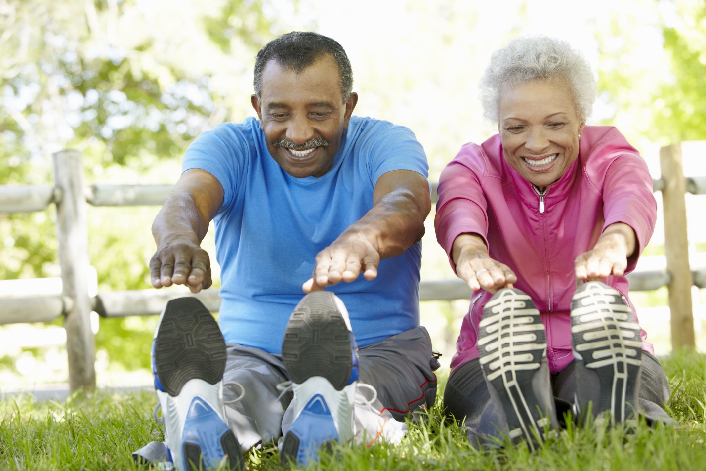 A husband and wife stretching is one of the types of exercises for seniors
