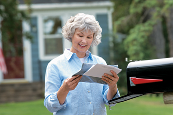 A lady checking for her new Medicare card in the mail