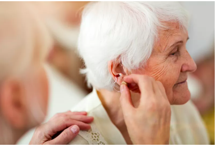 Elderly lady enjoying her free services for senior citizens in the form of free hearing aids
